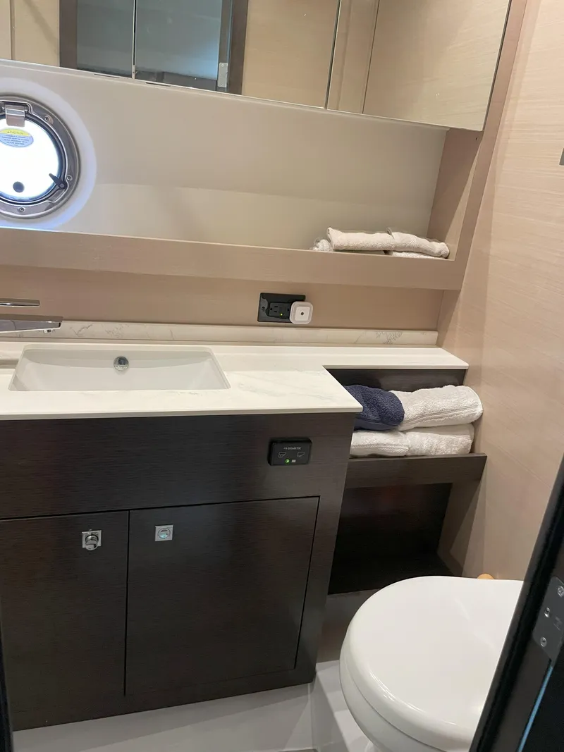 Slide: The Image of Luxurious bathroom in 2021 Cruisers Yachts 54 Cantius with modern fixtures and porthole window. - 29