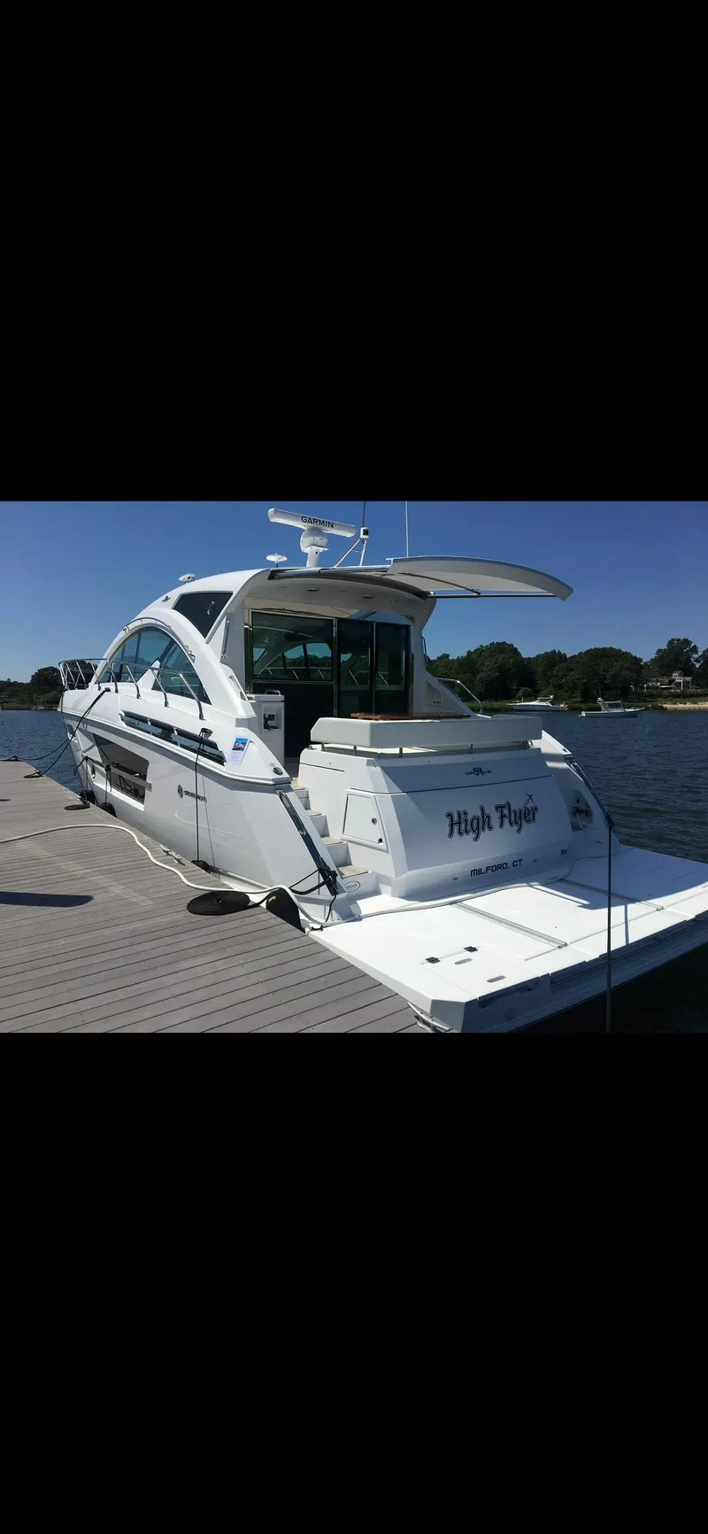 Slide: The Image of 2021 Cruisers Yachts 54 Cantius docked, rear view, sunny day. - 33