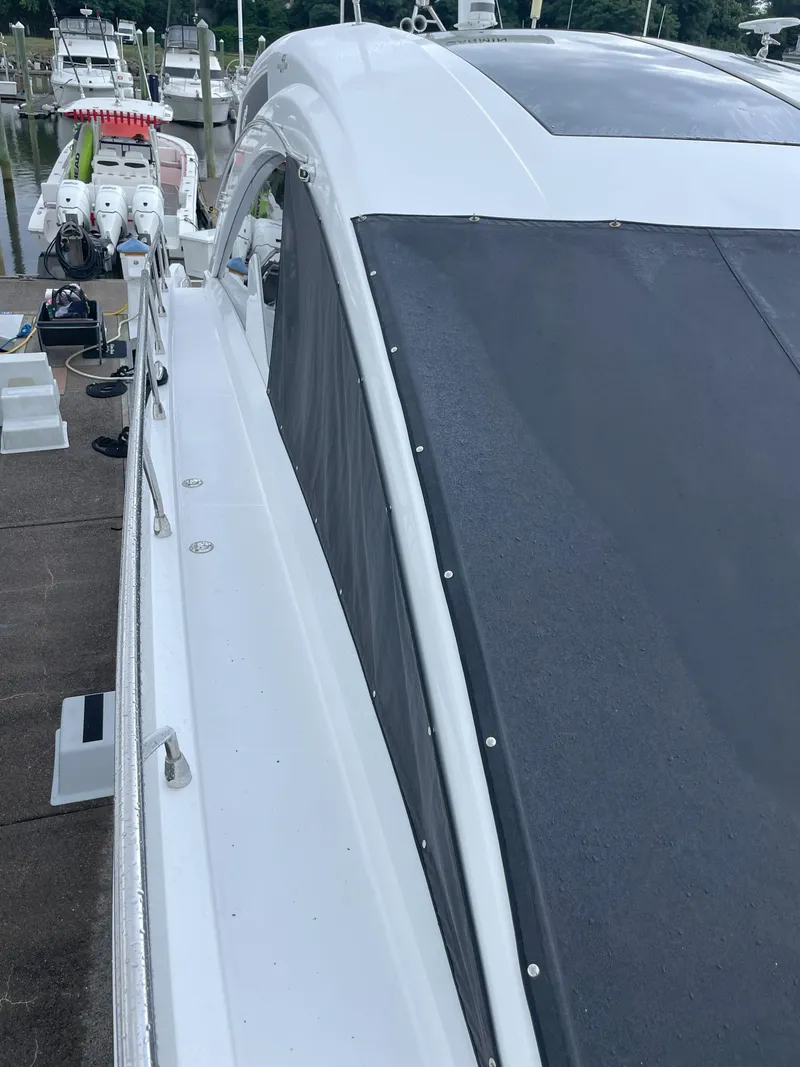 Slide: The Image of 2021 Cruisers Yachts 54 Cantius docked, showcasing sleek design and modern features. - 37