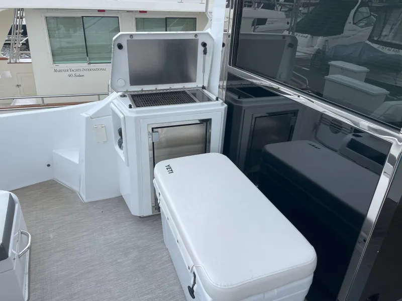 Slide: The Image of 2021 Cruisers Yachts 54 Cantius outdoor kitchen with grill and cooler. - 38