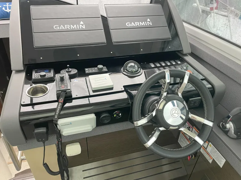 Slide: The Image of 2021 Cruisers Yachts 54 Cantius helm with Garmin navigation system and steering wheel. - 40