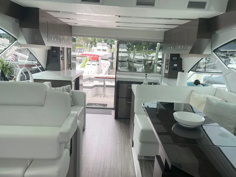 Slide: The Image of Luxurious interior of 2021 Cruisers Yachts 54 Cantius with modern furnishings and marina view. - 41