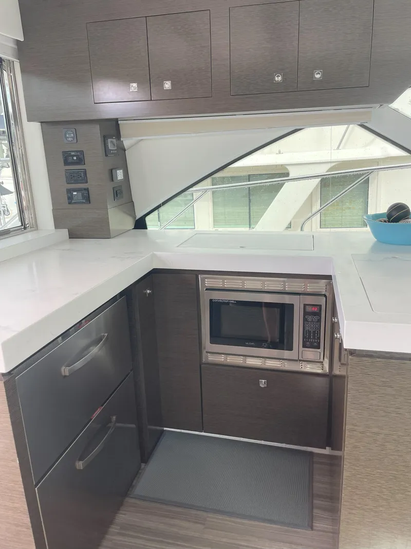 Slide: The Image of Modern kitchen in 2021 Cruisers Yachts 54 Cantius with sleek cabinetry and microwave. - 43
