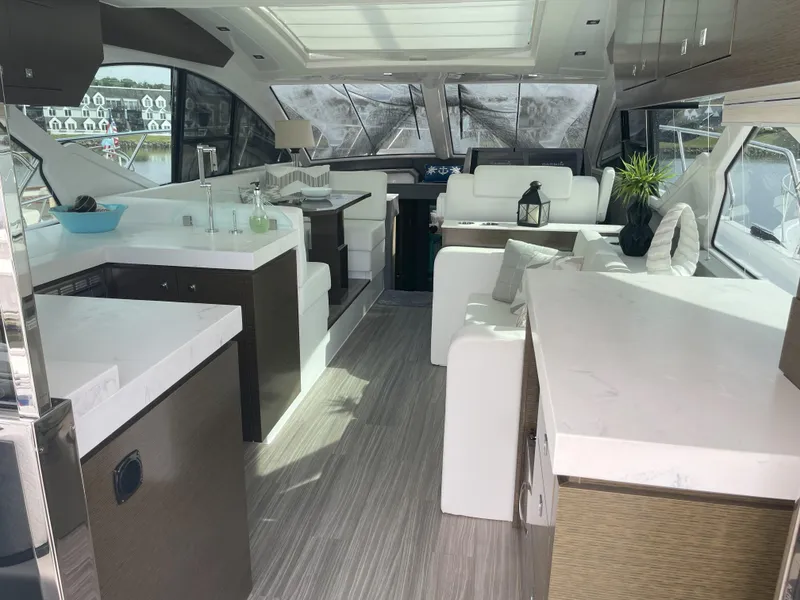 Slide: The Image of Luxurious interior of 2021 Cruisers Yachts 54 Cantius with modern furnishings and panoramic windows. - 44