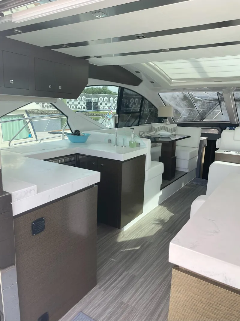 Slide: The Image of Luxurious interior of 2021 Cruisers Yachts 54 Cantius with modern kitchen and seating area. - 45