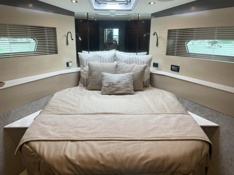 Slide: The Image of Luxurious bedroom interior of 2021 Cruisers Yachts 54 Cantius with elegant bedding. - 6