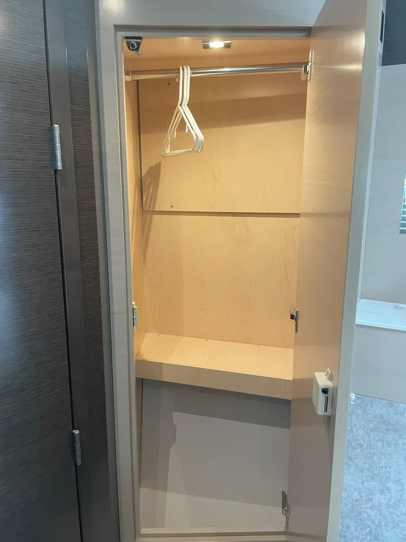 Slide: The Image of 2021 Cruisers Yachts 54 Cantius closet interior with hangers and lighting. - 7