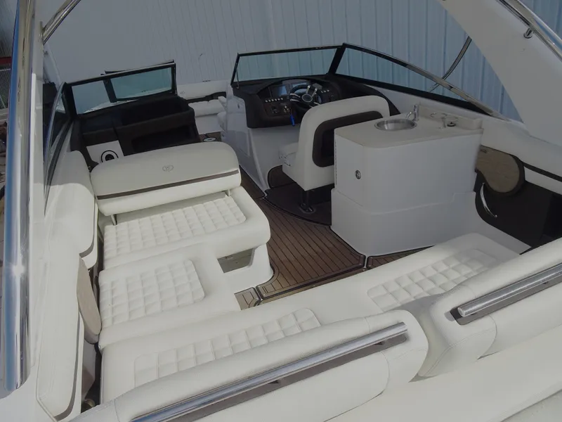 Slide: The Image of 2018 Cobalt R30 boat interior with white leather seating and modern dashboard. - 11