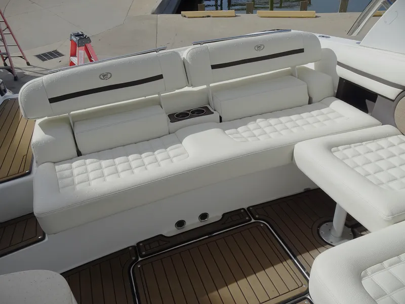 Slide: The Image of 2018 Cobalt R30 boat interior with white cushioned seating and wooden flooring. - 13