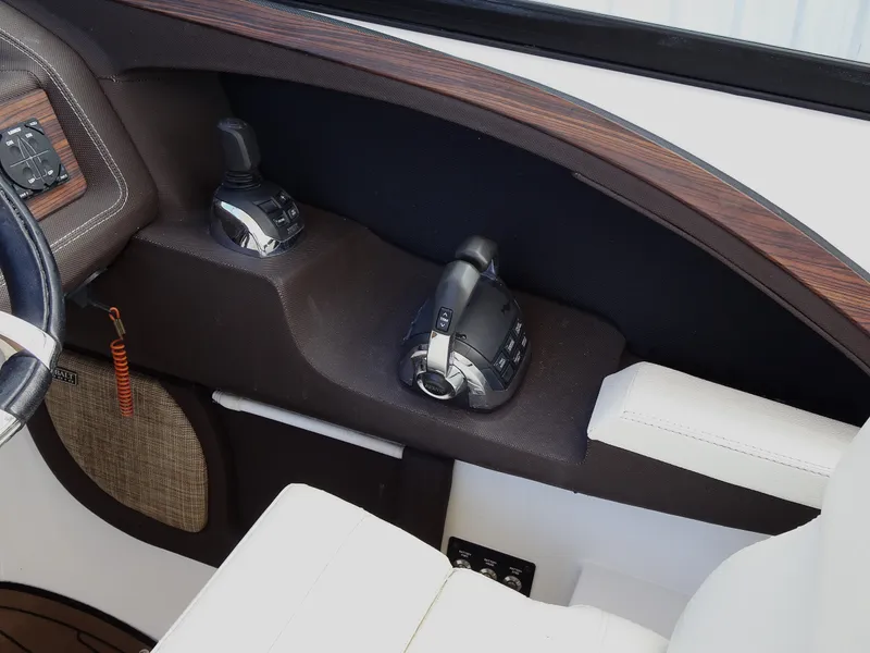 Slide: The Image of Control panel of a 2018 Cobalt R30 boat with throttle and joystick. - 18