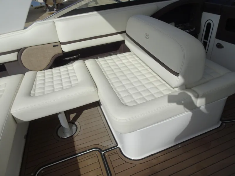Slide: The Image of 2018 Cobalt R30 boat interior with white cushioned seating and wooden flooring. - 21