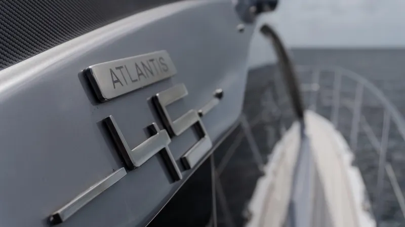 Slide: The Image of 2023 Azimut Atlantis 45 yacht, close-up of model name on sleek exterior. - 12
