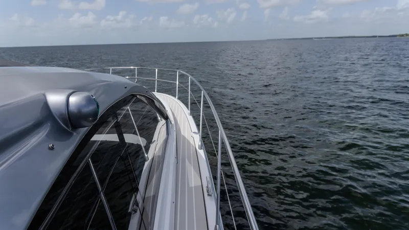 Slide: The Image of 2023 Azimut Atlantis 45 yacht cruising on open water under a clear sky. - 16