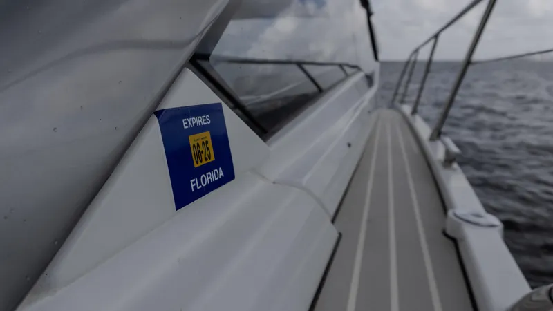 Slide: The Image of 2023 Azimut Atlantis 45 yacht with Florida registration sticker, cruising on open water. - 27