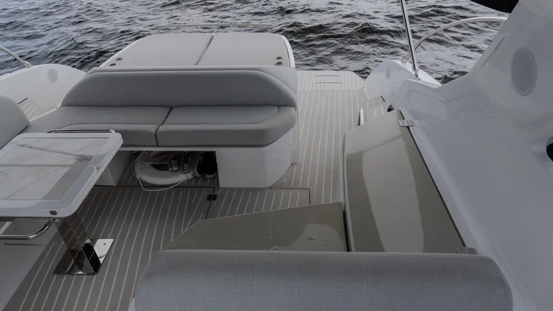 Slide: The Image of 2023 Azimut Atlantis 45 yacht deck with seating and table, overlooking the ocean. - 30