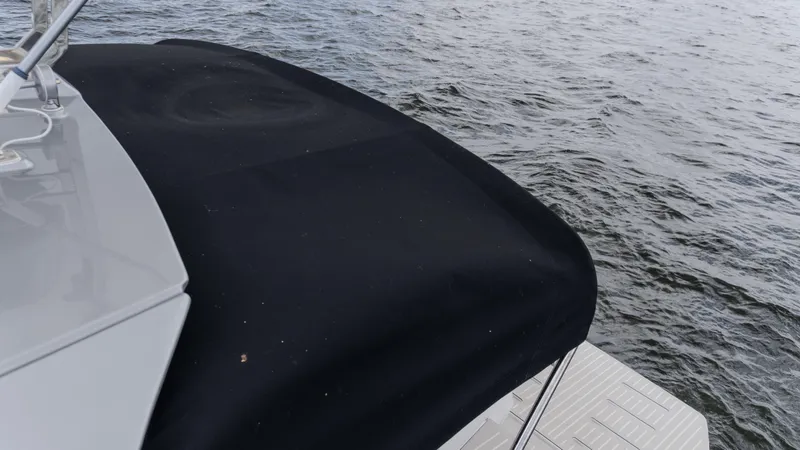 Slide: The Image of 2023 Azimut Atlantis 45 yacht with black cover on water. - 34