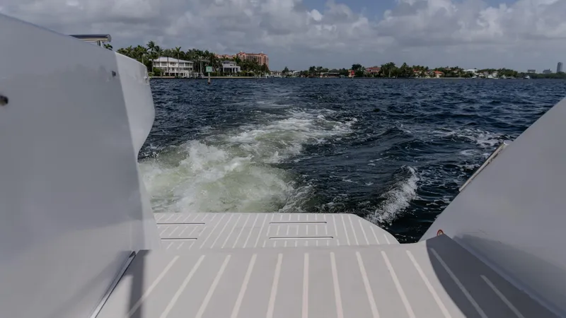 Slide: The Image of 2023 Azimut Atlantis 45 yacht cruising on open water with scenic shoreline view. - 35