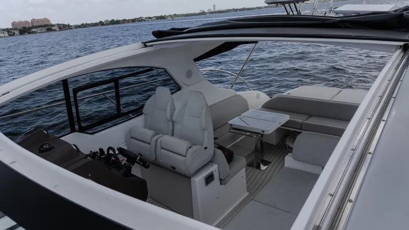 Slide: The Image of 2023 Azimut Atlantis 45 yacht interior with luxurious seating and table on open water. - 36