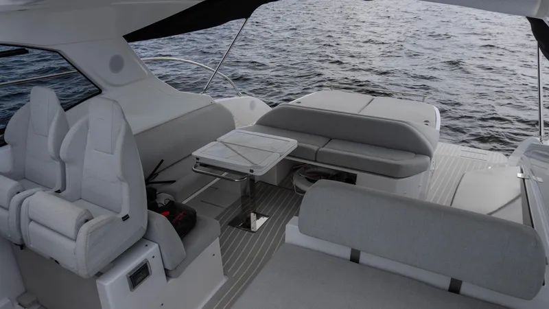 Slide: The Image of 2023 Azimut Atlantis 45 yacht interior with seating and table on open water. - 38