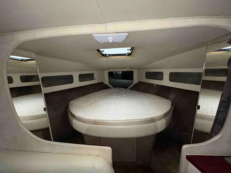 Slide: The Image of Interior cabin of 1991 Silverton 34 Express Cruiser with a cozy bed setup. - 15