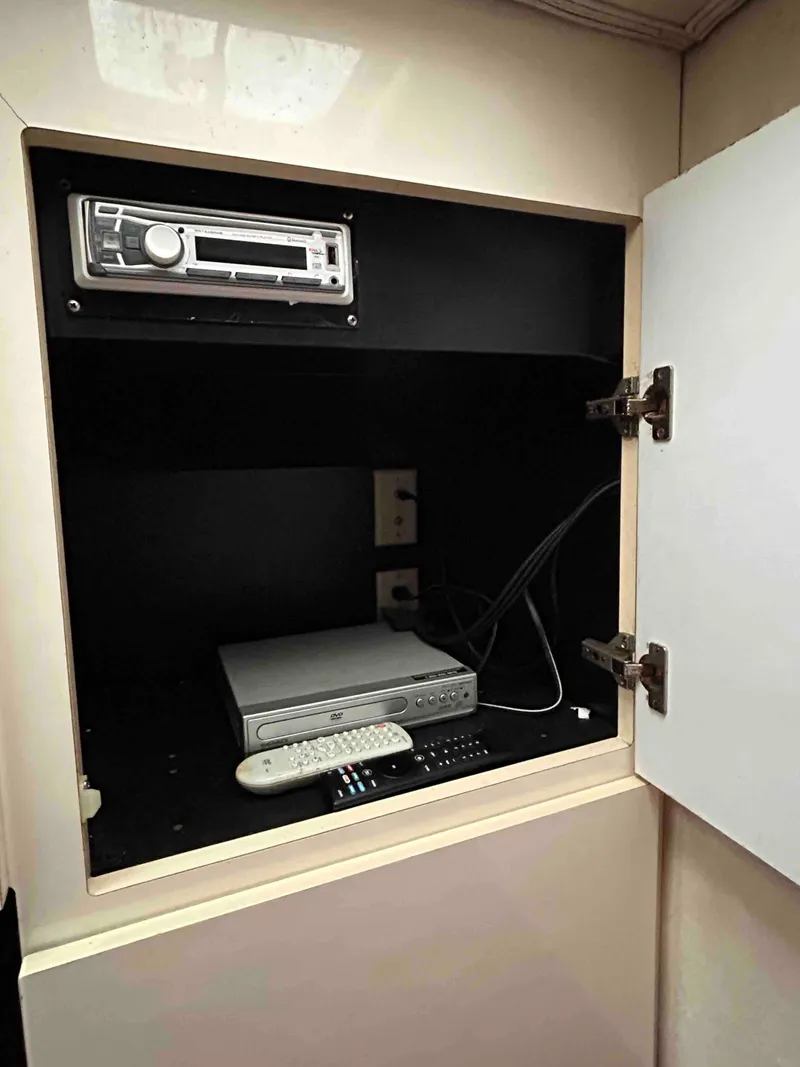 Slide: The Image of Cabinet with stereo and electronic device in 1991 Silverton 34 Express Cruiser. - 19