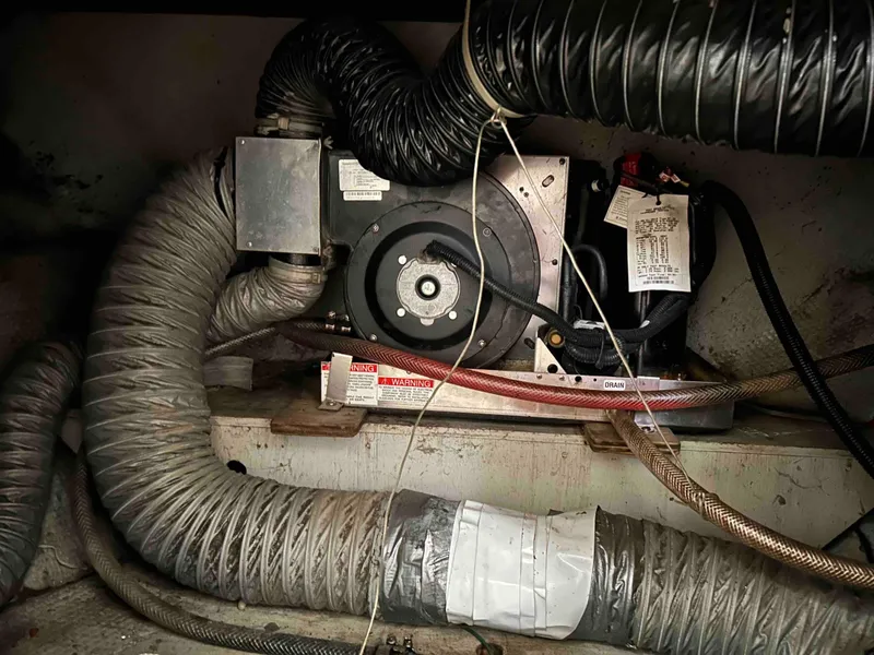 Slide: The Image of 1991 Silverton 34 Express Cruiser engine compartment with ventilation hoses and mechanical components. - 21