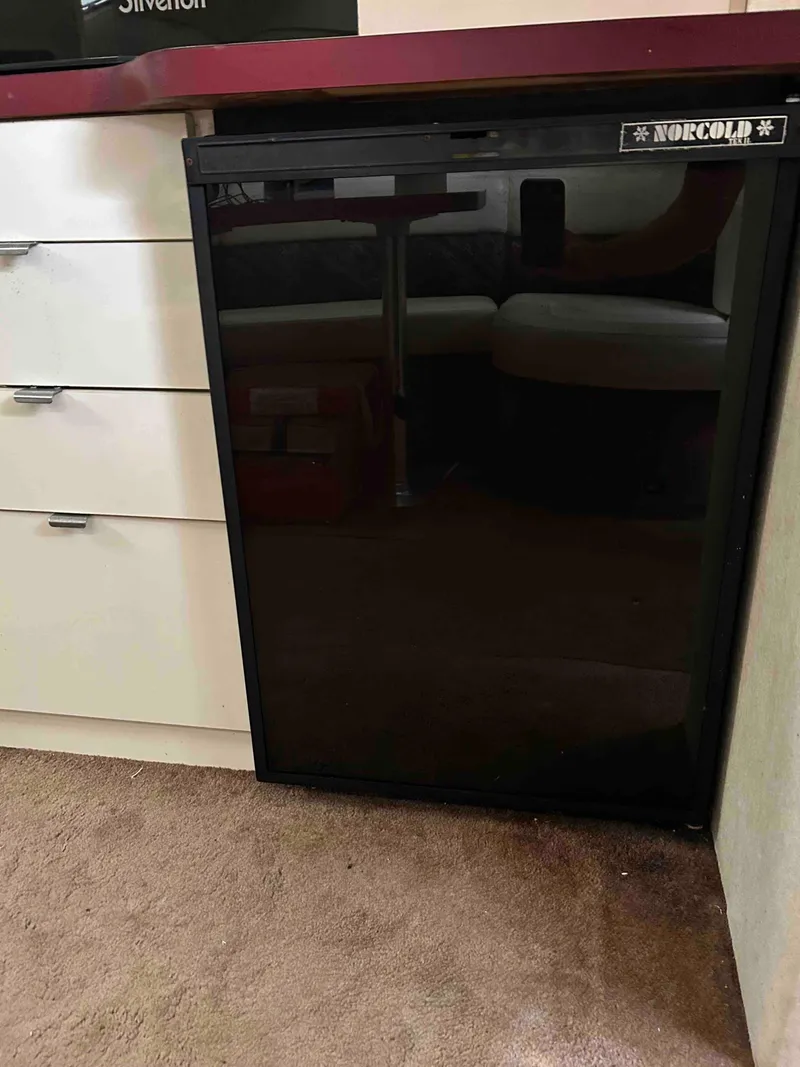 Slide: The Image of Norcold mini fridge in a 1991 Silverton 34 Express Cruiser interior. - 22