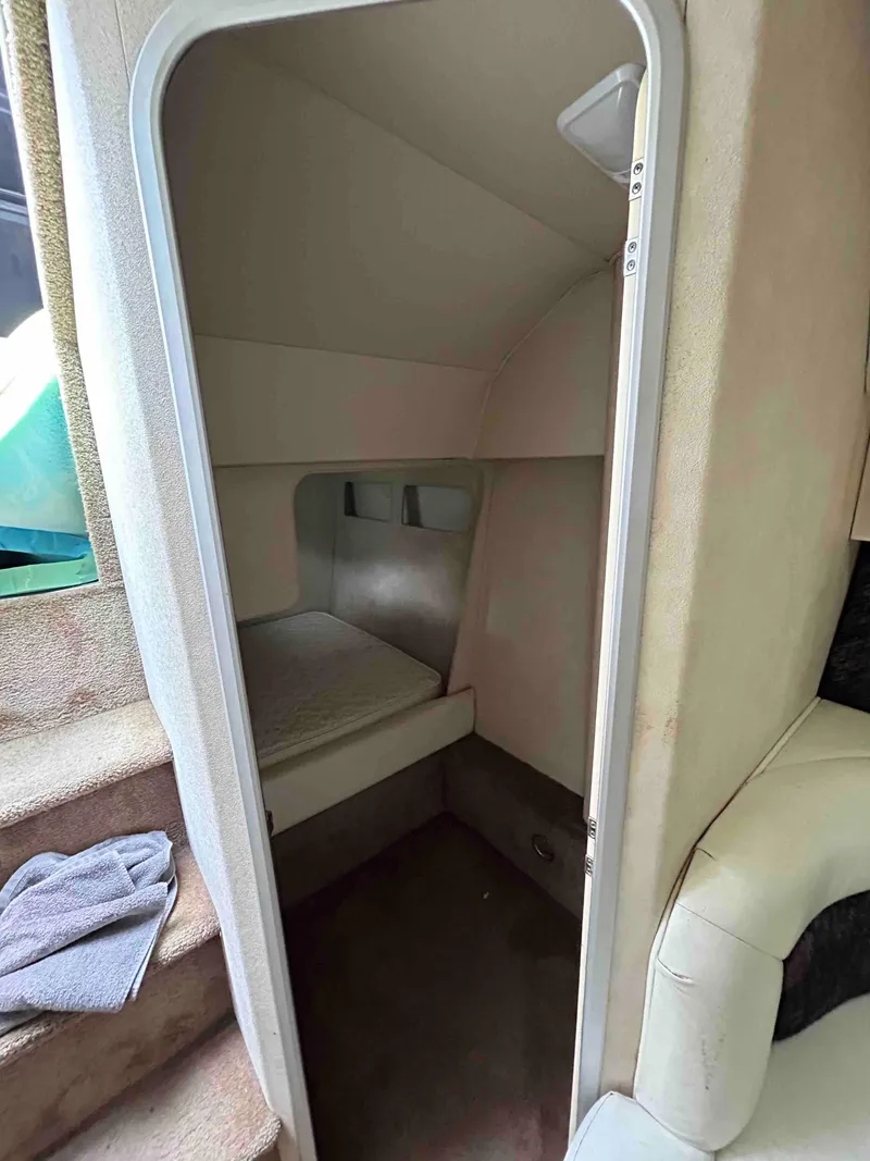 Slide: The Image of 1991 Silverton 34 Express Cruiser cabin interior with bed and stairs. - 23