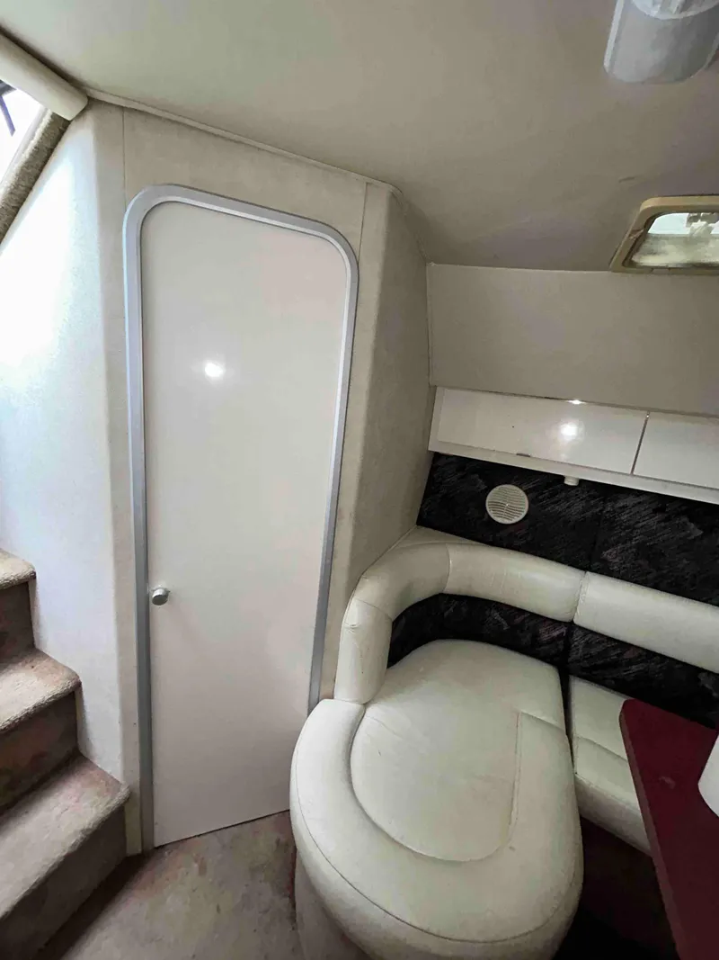 Slide: The Image of Interior of 1991 Silverton 34 Express Cruiser with white seating and modern design. - 25