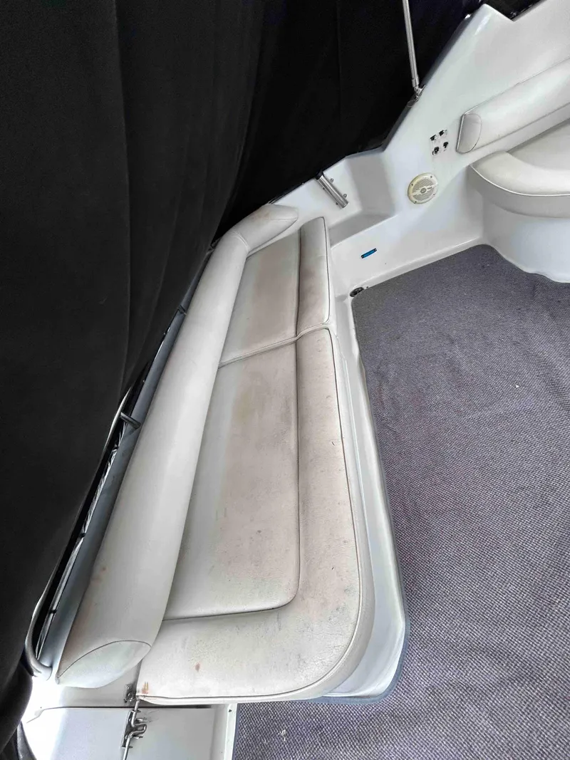 Slide: The Image of 1991 Silverton 34 Express Cruiser interior with white seating and carpeted floor. - 5