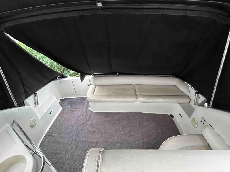 Slide: The Image of 1991 Silverton 34 Express Cruiser interior with cushioned seating and black canopy. - 6