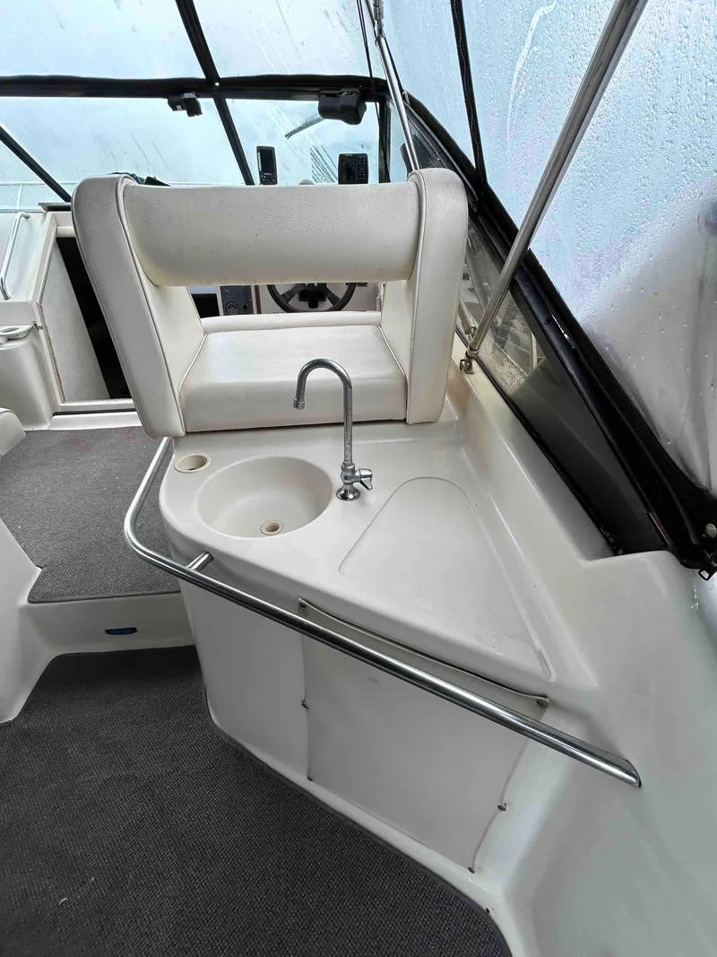 Slide: The Image of 1991 Silverton 34 Express Cruiser interior with sink and seating area. - 7