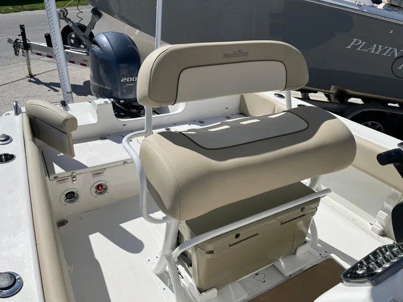 Slide: The Image of 2022 NauticStar 2302 Legacy boat interior with seating and Yamaha 200 engine. - 6