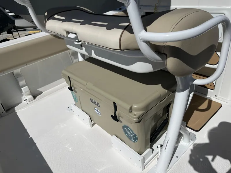 Slide: The Image of 2022 NauticStar 2302 Legacy boat interior with cushioned seating and cooler. - 9
