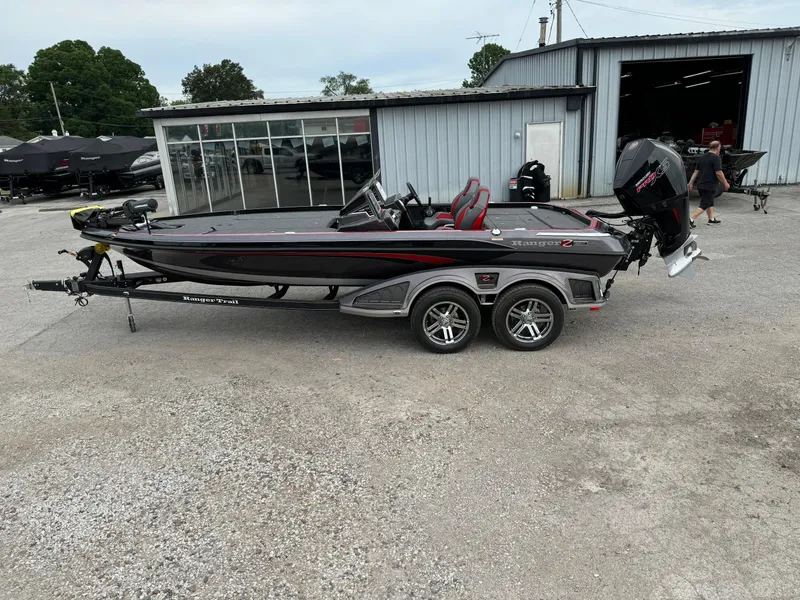 Slide: The Image of 2024 Ranger Z520R Ranger Cup Equipped boat on trailer outside a garage. - 1
