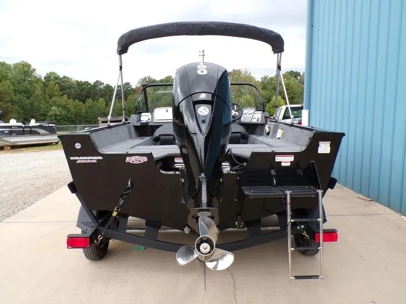Slide: The Image of 2025 Tracker Pro Guide V-175 Combo boat, rear view with motor and ladder. - 5