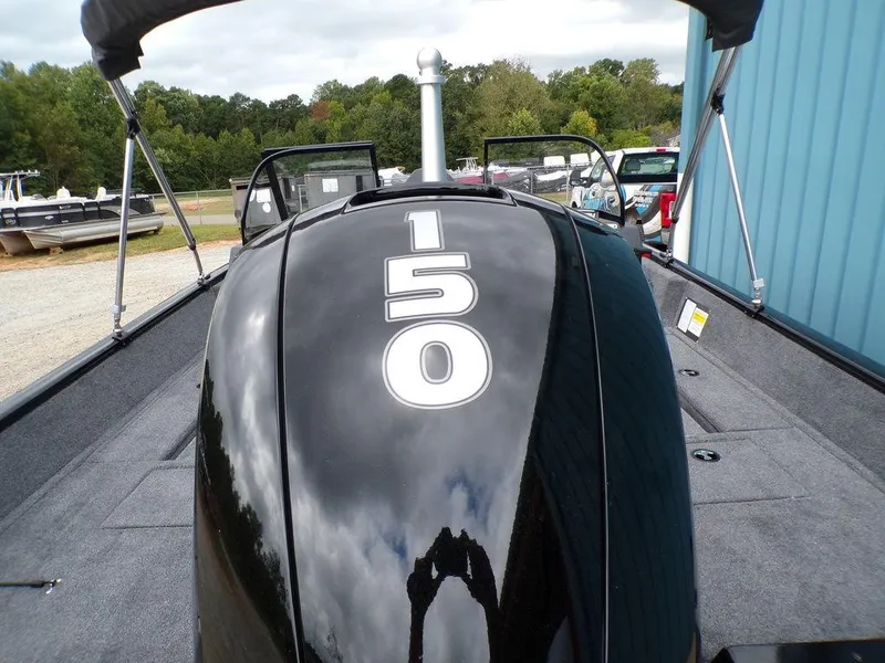 Slide: The Image of 2025 Tracker Pro Guide™ V-175 Combo boat with 150 horsepower engine, docked outdoors. - 7