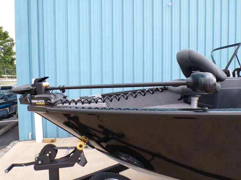 Slide: The Image of 2025 Tracker Pro Guide™ V-175 Combo boat with trolling motor, parked by blue wall. - 8