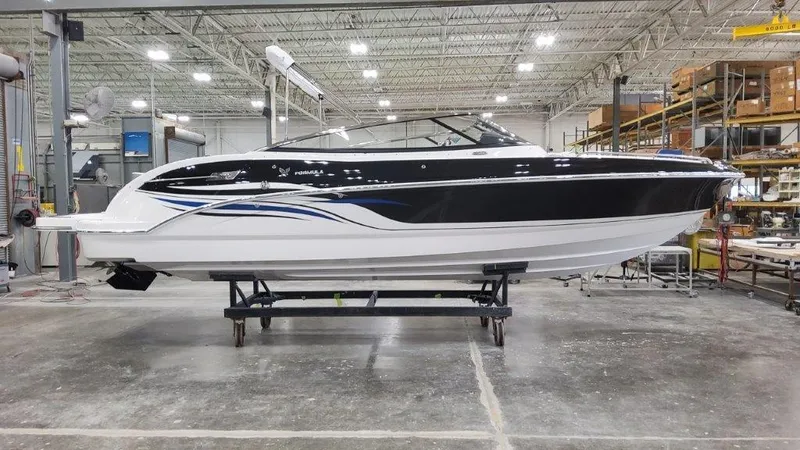 Slide: The Image of 2025 Formula 240 Bowrider boat in a warehouse. - 0