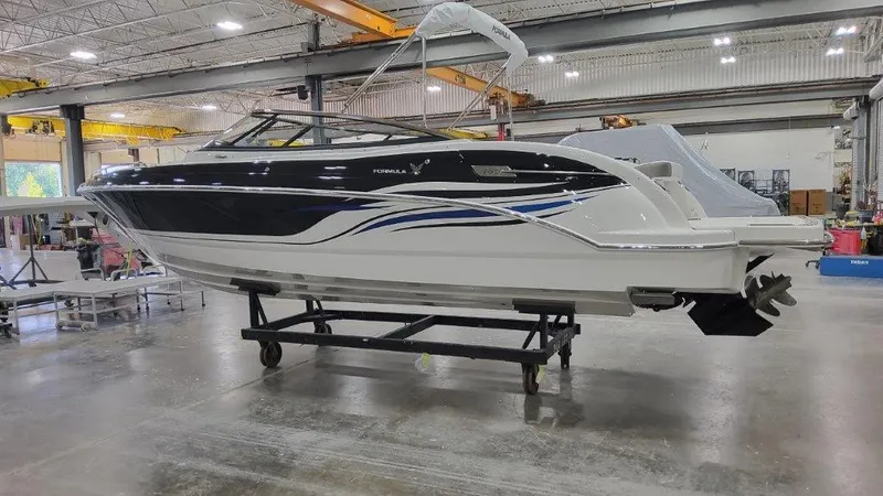 Slide: The Image of 2025 Formula 240 Bowrider boat in a warehouse. - 1