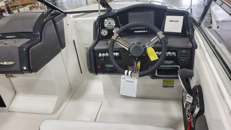 Slide: The Image of 2025 Formula 240 Bowrider dashboard and steering wheel in a showroom. - 10