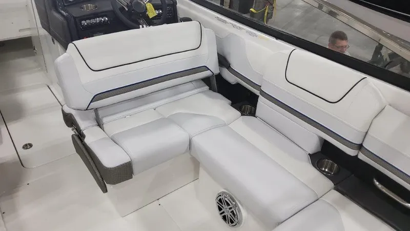 Slide: The Image of 2025 Formula 240 Bowrider interior seating with white upholstery and integrated speaker. - 12