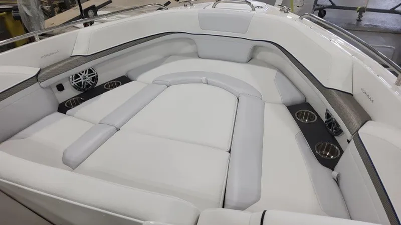 Slide: The Image of 2025 Formula 240 Bowrider boat interior with white cushioned seating and cup holders. - 14
