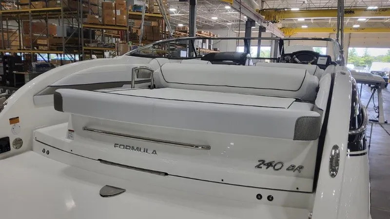Slide: The Image of 2025 Formula 240 Bowrider boat in a warehouse, rear view. - 17
