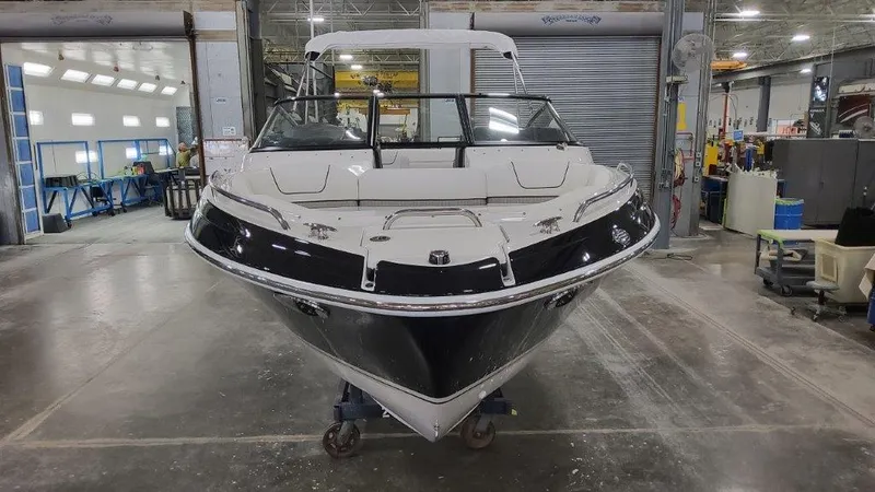 Slide: The Image of 2025 Formula 240 Bowrider boat in a warehouse. - 4