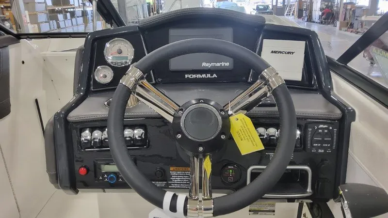 Slide: The Image of 2025 Formula 240 Bowrider dashboard with steering wheel and control panel. - 5