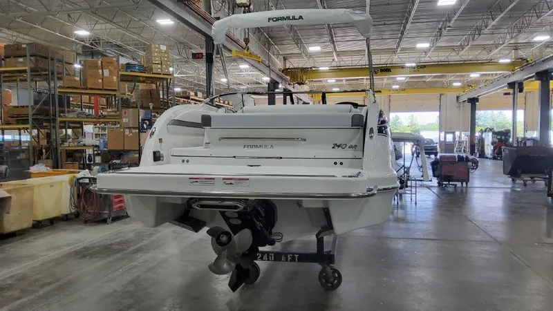 Slide: The Image of 2025 Formula 240 Bowrider boat in a warehouse, rear view. - 6