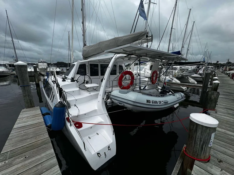 Slide: The Image of 2023 Seawind 1160 Lite catamaran docked at marina with dinghy. - 9