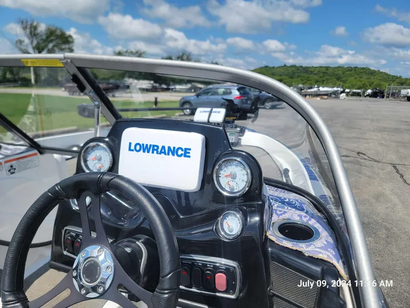 Slide: The Image of 2018 Nitro Z19 Sport boat dashboard with Lowrance display, steering wheel, and gauges. - 11