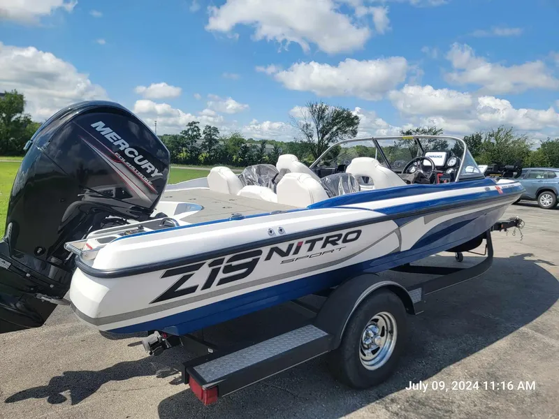 Slide: The Image of 2018 Nitro Z19 Sport boat with Mercury engine on trailer, parked outdoors. - 7